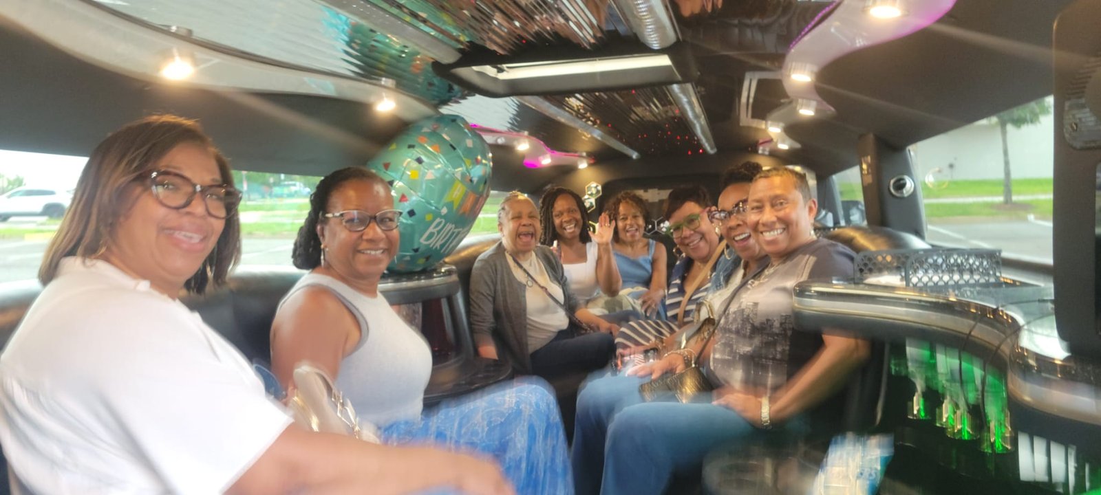 Birthday group celebrating inside a white Hummer Stretch Limousine