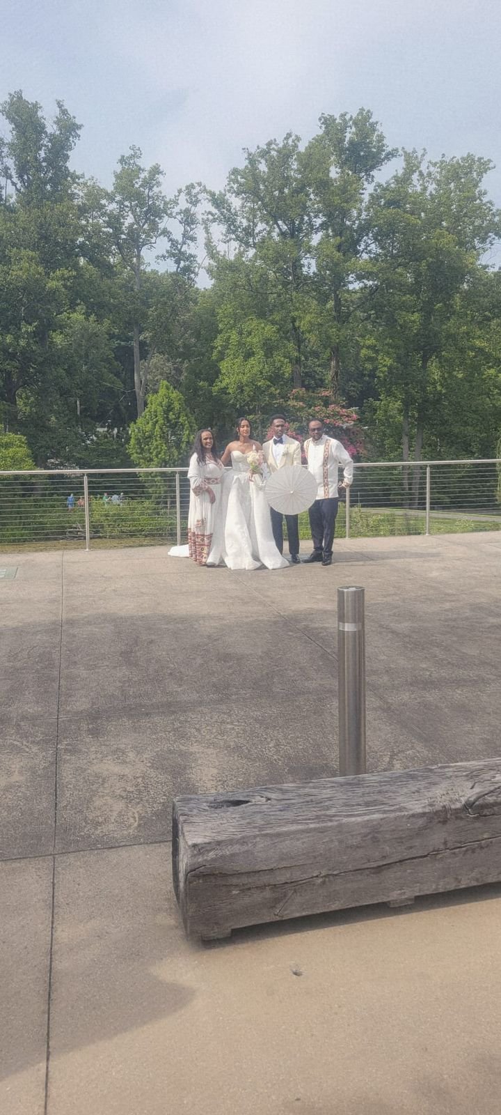 Bride and wedding party standing together outdoors during the wedding celebration