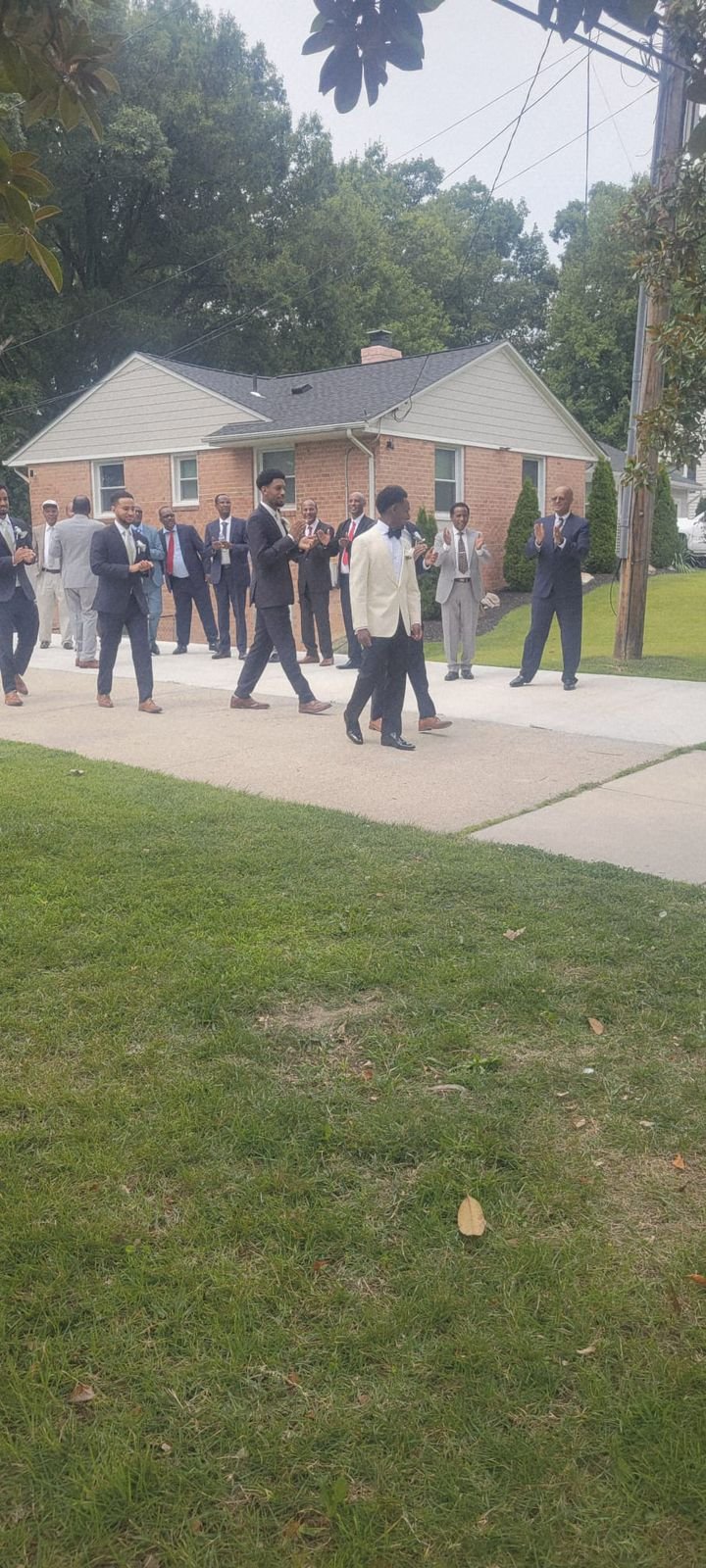 Wedding party and guests gathered outdoors during a wedding celebration